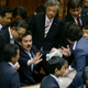 Opposition lawmakers surround Masahisa Sato (C-L), deputy chairman of the upper chamber special committee on security legislation. EPA/Kimimasa Mayama.